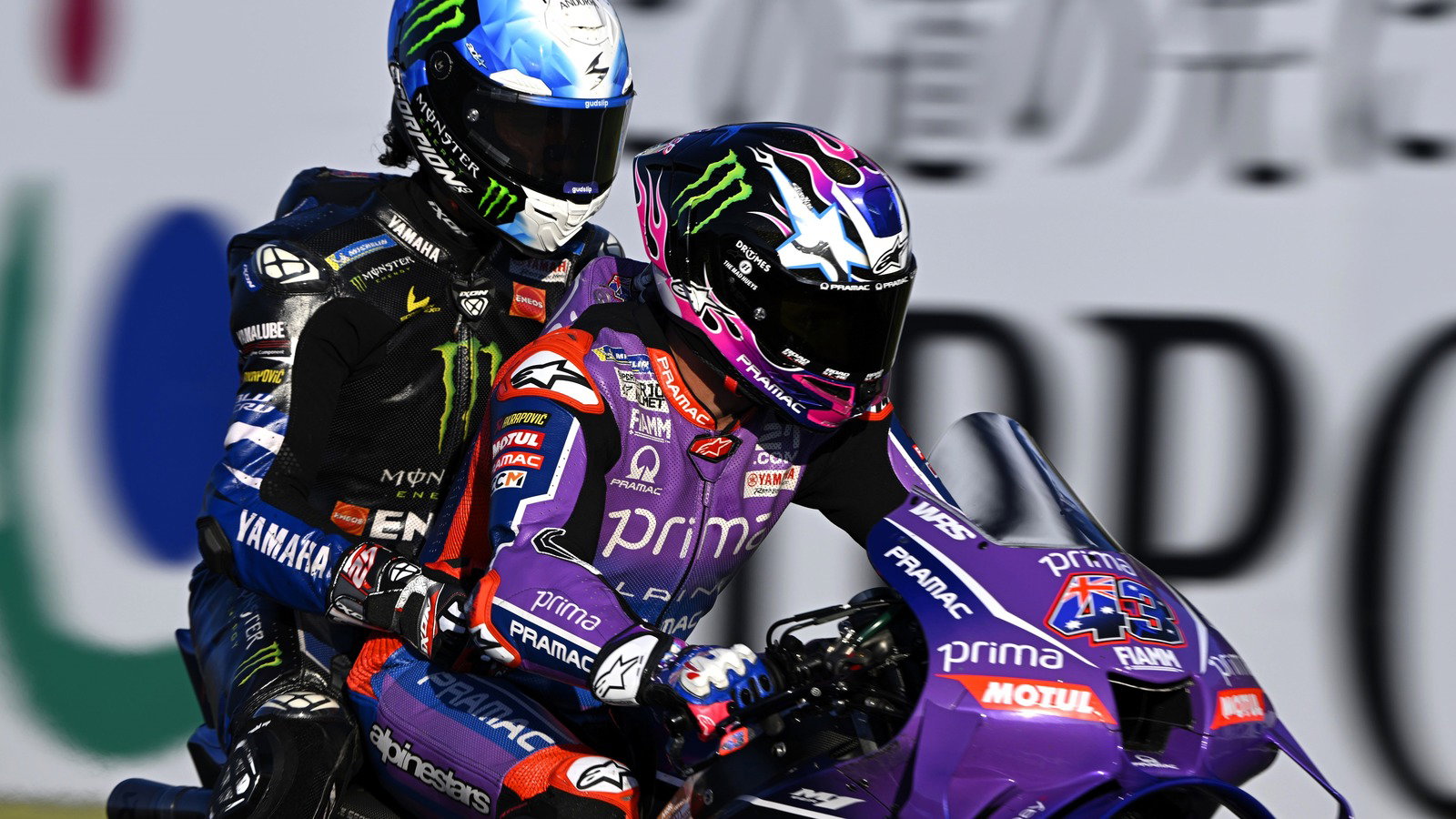 Miller gives Rins a lift — and pulls a stoppie at Motegi